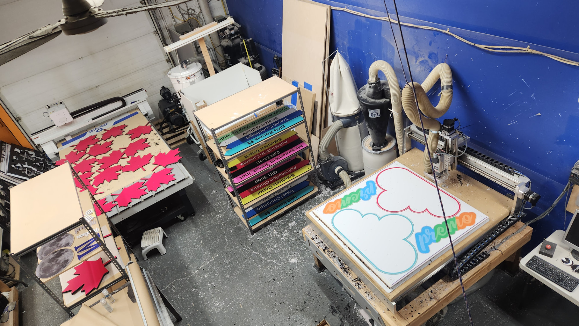Our workshop today, with machines cutting custom signs for orders